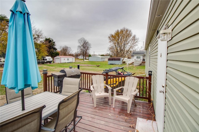 wooden terrace with area for grilling and a lawn