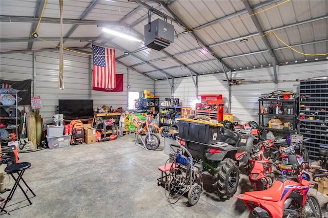 garage with a garage door opener and wood walls