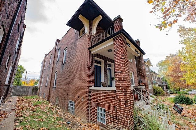 view of side of home with a balcony