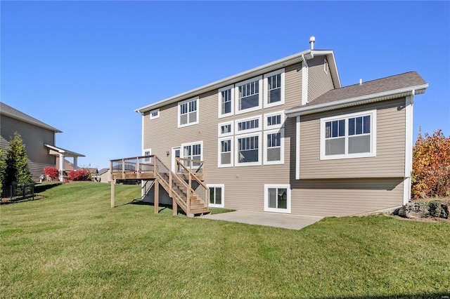 back of property featuring a deck, a yard, and a patio