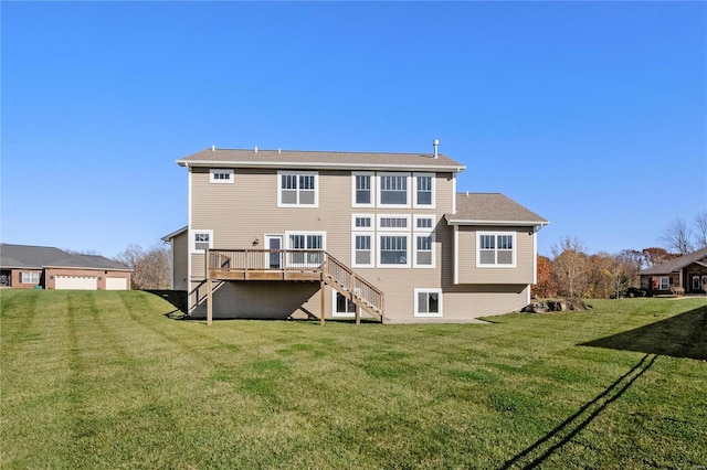 back of property with a yard and a wooden deck