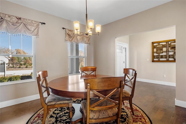 dining room with a notable chandelier and dark hardwood / wood-style floors