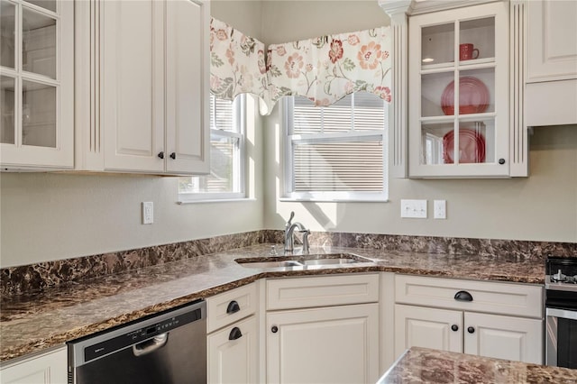 kitchen featuring stainless steel appliances, white cabinetry, and sink