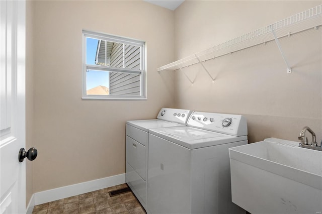 washroom with sink and independent washer and dryer