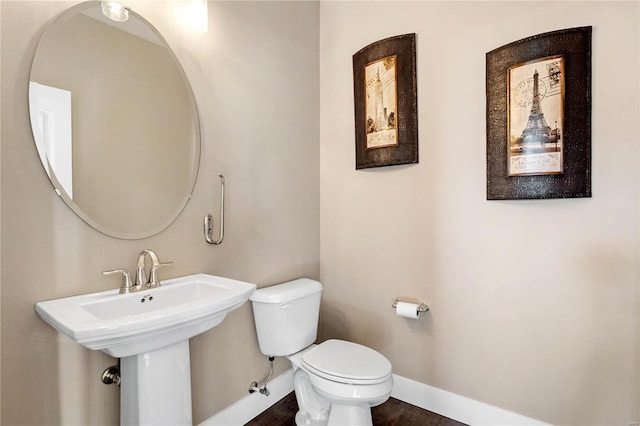 bathroom with hardwood / wood-style floors and toilet