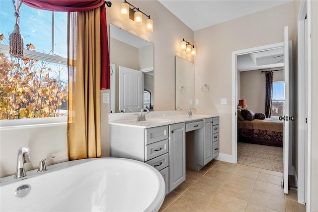 bathroom with tile patterned floors, vanity, and a bathing tub