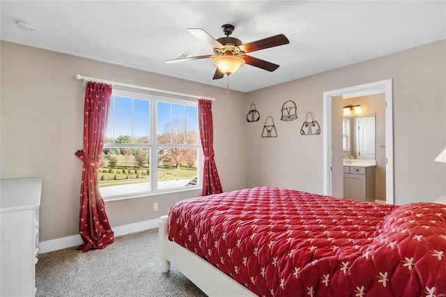 carpeted bedroom with ceiling fan and ensuite bathroom