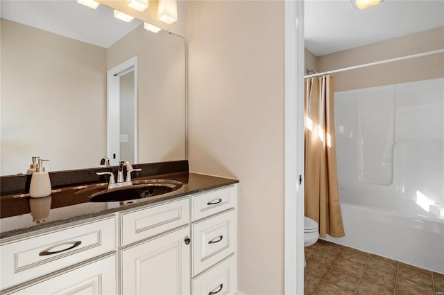 full bathroom featuring tile patterned floors, vanity, shower / bath combination with curtain, and toilet