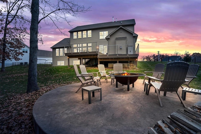 exterior space with a patio area, a yard, a deck, and an outdoor fire pit