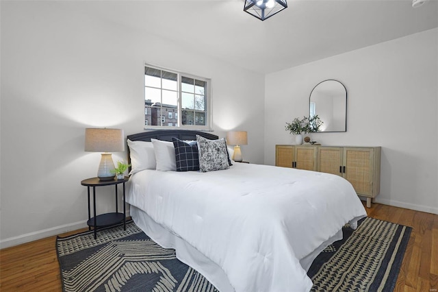 bedroom with dark wood-type flooring