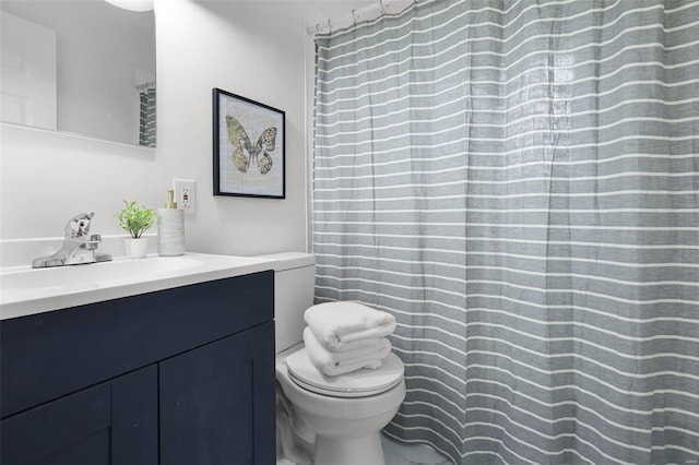 bathroom featuring vanity and toilet