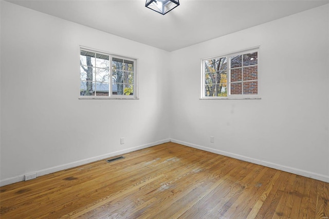 unfurnished room featuring light hardwood / wood-style floors