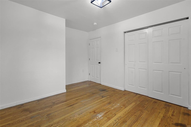 unfurnished bedroom featuring a closet and wood-type flooring