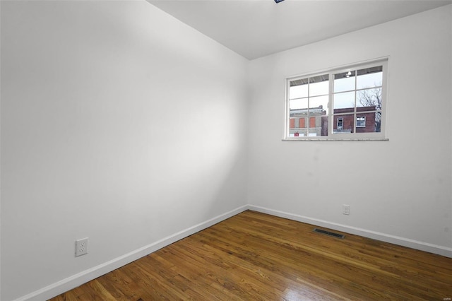 empty room featuring dark wood-type flooring