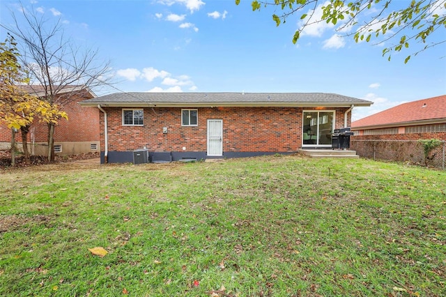 rear view of house featuring a lawn