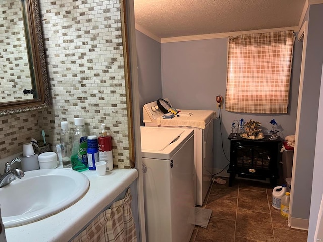 bathroom featuring tile patterned floors, decorative backsplash, sink, and a textured ceiling