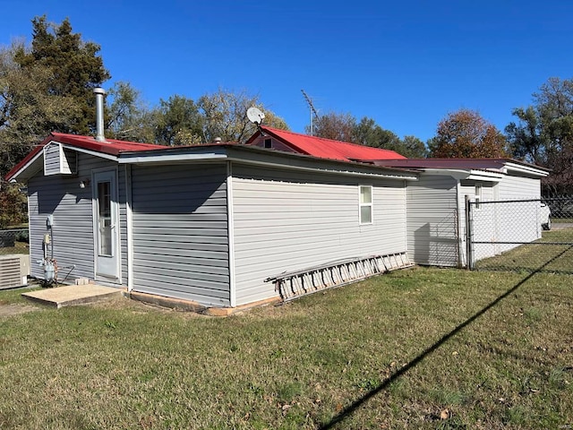 view of property exterior featuring a lawn