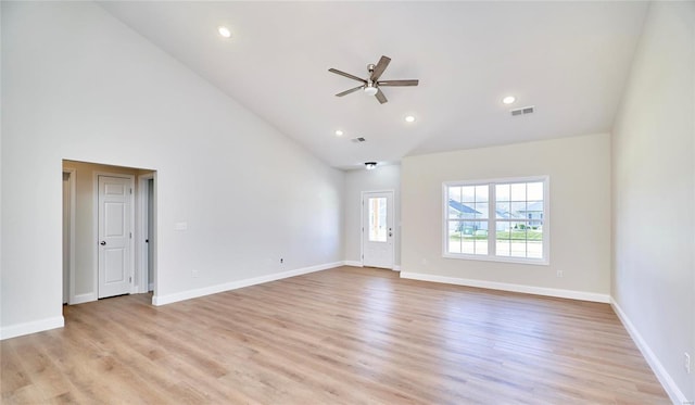 empty room featuring ceiling fan, light hardwood / wood-style floors, and high vaulted ceiling