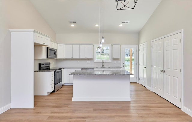 kitchen featuring a center island, white cabinetry, and stainless steel appliances