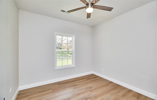 spare room with ceiling fan and light wood-type flooring