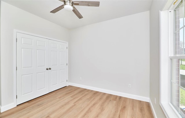 unfurnished bedroom with ceiling fan, a closet, and light hardwood / wood-style flooring