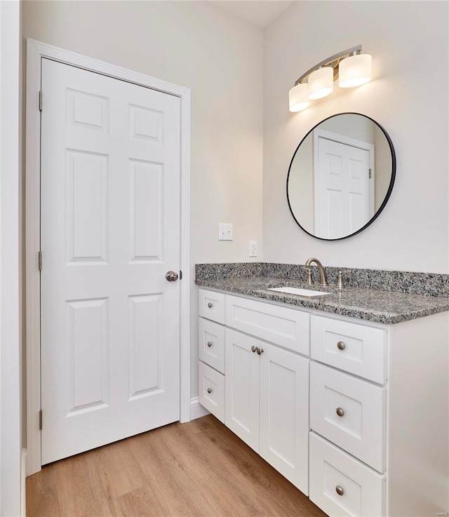 bathroom with vanity and hardwood / wood-style flooring