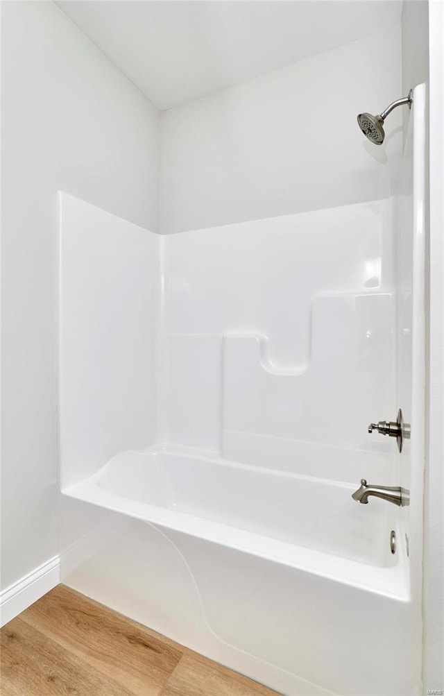 bathroom featuring shower / bath combination and hardwood / wood-style flooring