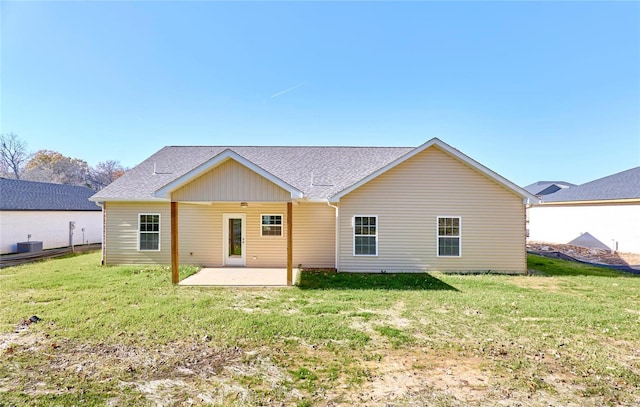 rear view of property featuring a yard and a patio