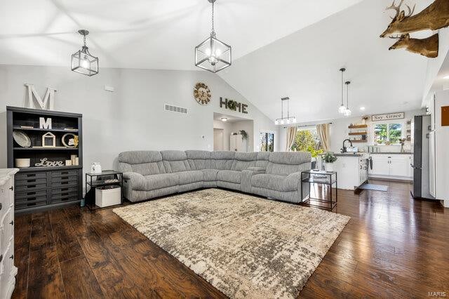 living room with dark hardwood / wood-style flooring and lofted ceiling