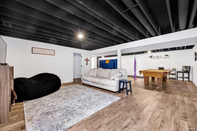 living room with hardwood / wood-style floors and billiards