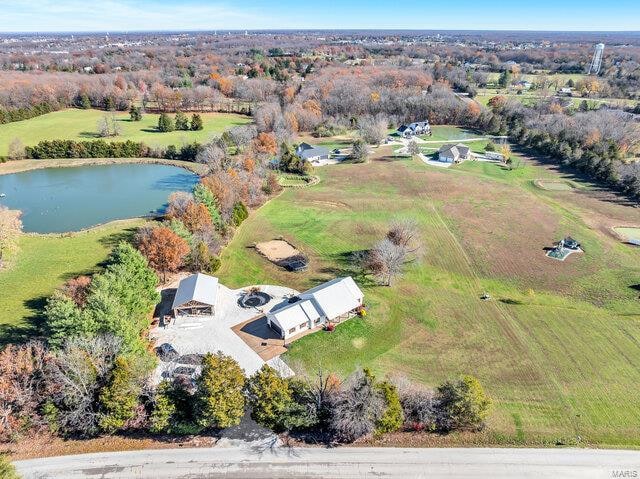 birds eye view of property featuring a rural view and a water view