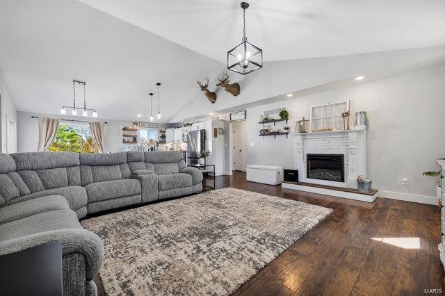 living room with dark hardwood / wood-style flooring and lofted ceiling