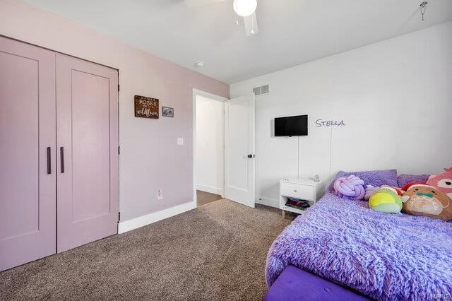 bedroom featuring ceiling fan and dark carpet