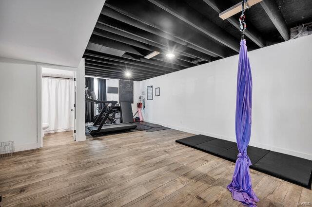 workout area with hardwood / wood-style floors