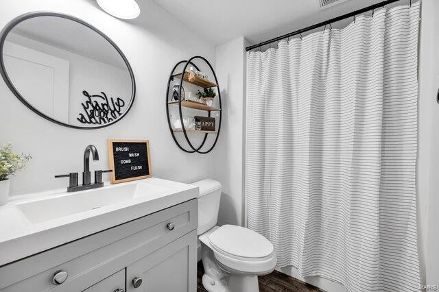 bathroom featuring hardwood / wood-style floors, vanity, and toilet