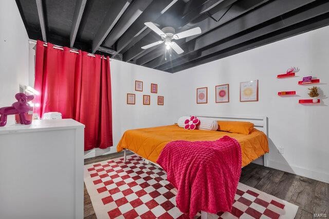 bedroom with ceiling fan and dark hardwood / wood-style flooring