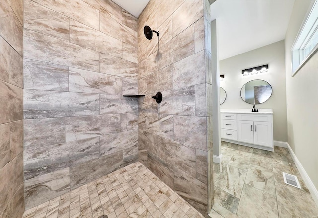 bathroom featuring vanity and a tile shower