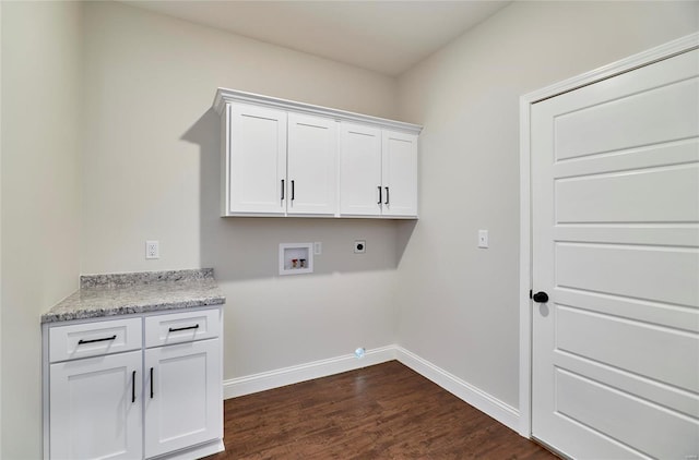 laundry area featuring electric dryer hookup, hookup for a washing machine, dark wood-type flooring, and cabinets