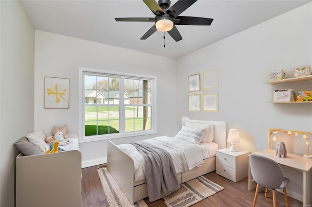 bedroom with dark hardwood / wood-style flooring and ceiling fan