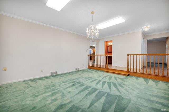 carpeted spare room featuring crown molding and a chandelier