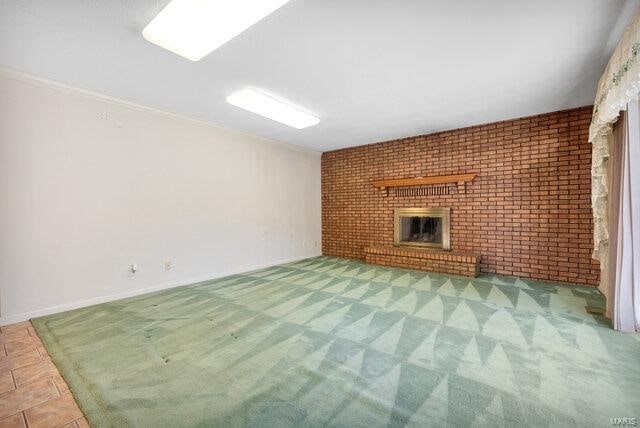 unfurnished living room with brick wall and a brick fireplace