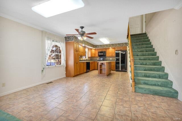 kitchen featuring black appliances, ceiling fan, ornamental molding, and tasteful backsplash