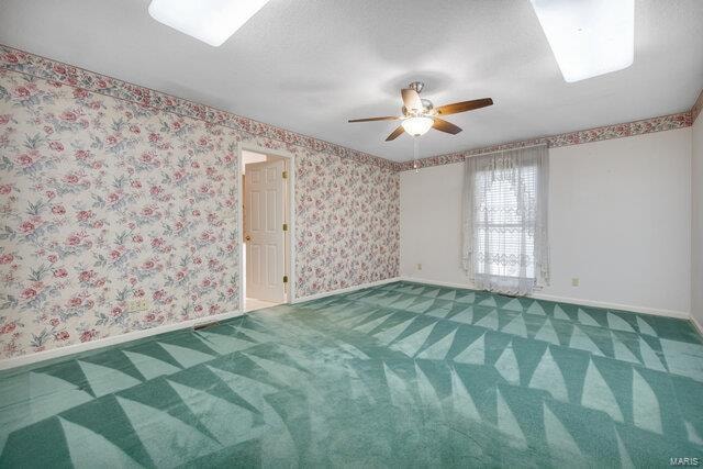 empty room featuring carpet and ceiling fan