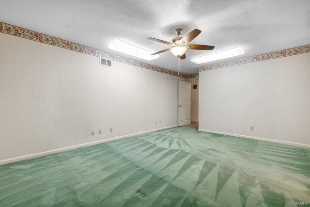 carpeted spare room featuring a textured ceiling