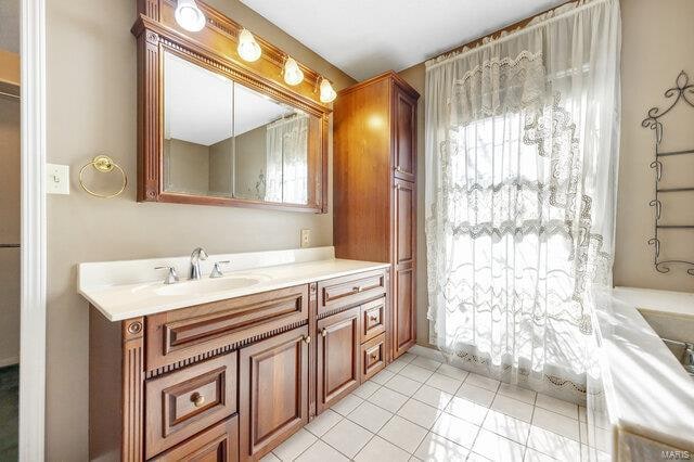 bathroom with tile patterned floors and vanity