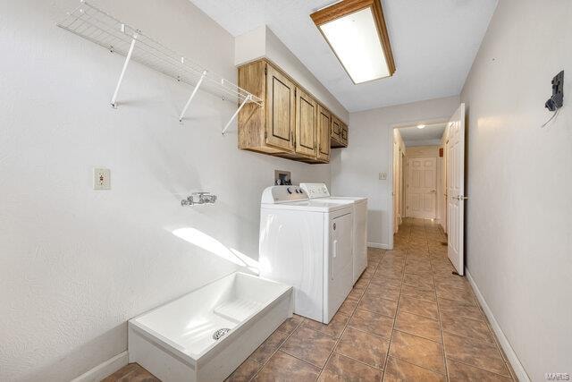 laundry room featuring cabinets and washing machine and dryer