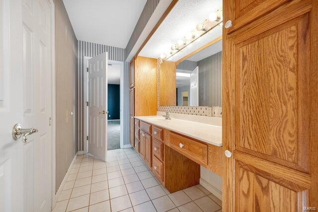 bathroom with tile patterned flooring and vanity