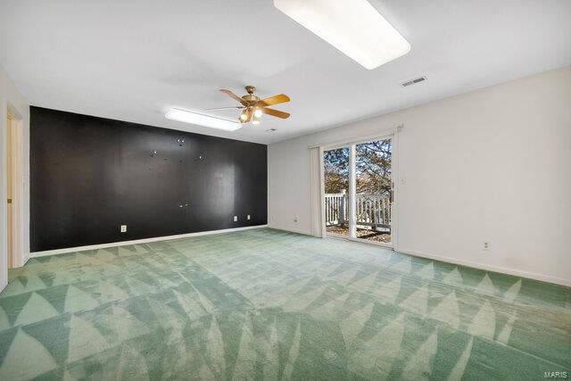 spare room featuring carpet flooring and ceiling fan