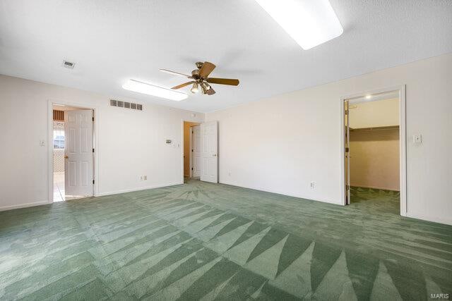 empty room with carpet flooring and ceiling fan