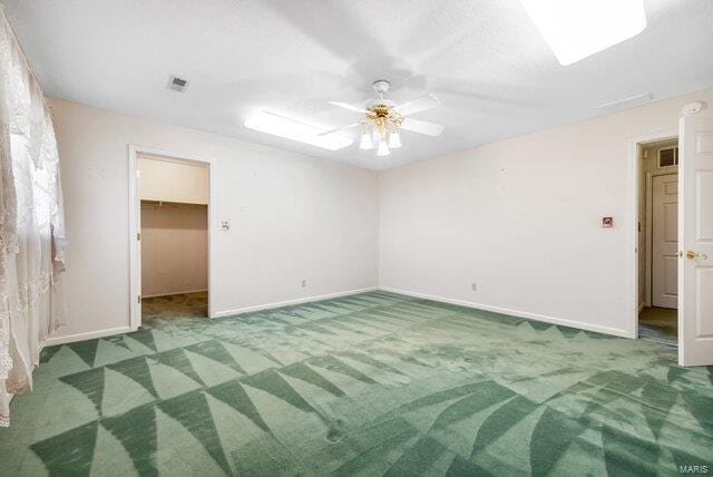 spare room featuring carpet flooring and ceiling fan